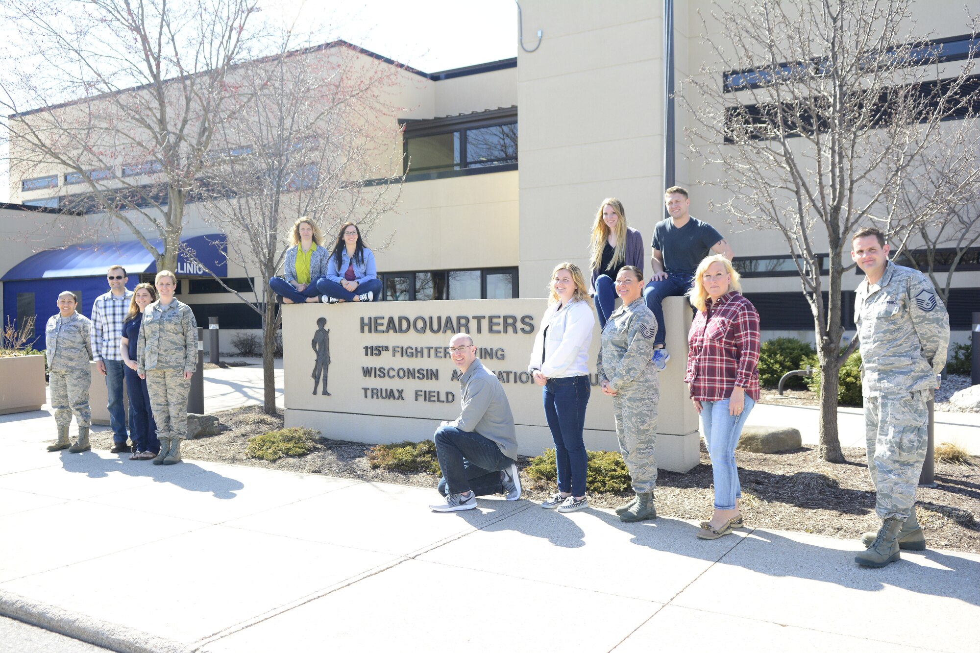 Force Support Squadron Airmen assigned to the 115th Fighter Wing show off their denim attire in front of the 115th Fighter Wing Headquarters sign at Truax Field, Wis. for National denim day, April 25th, 2018.