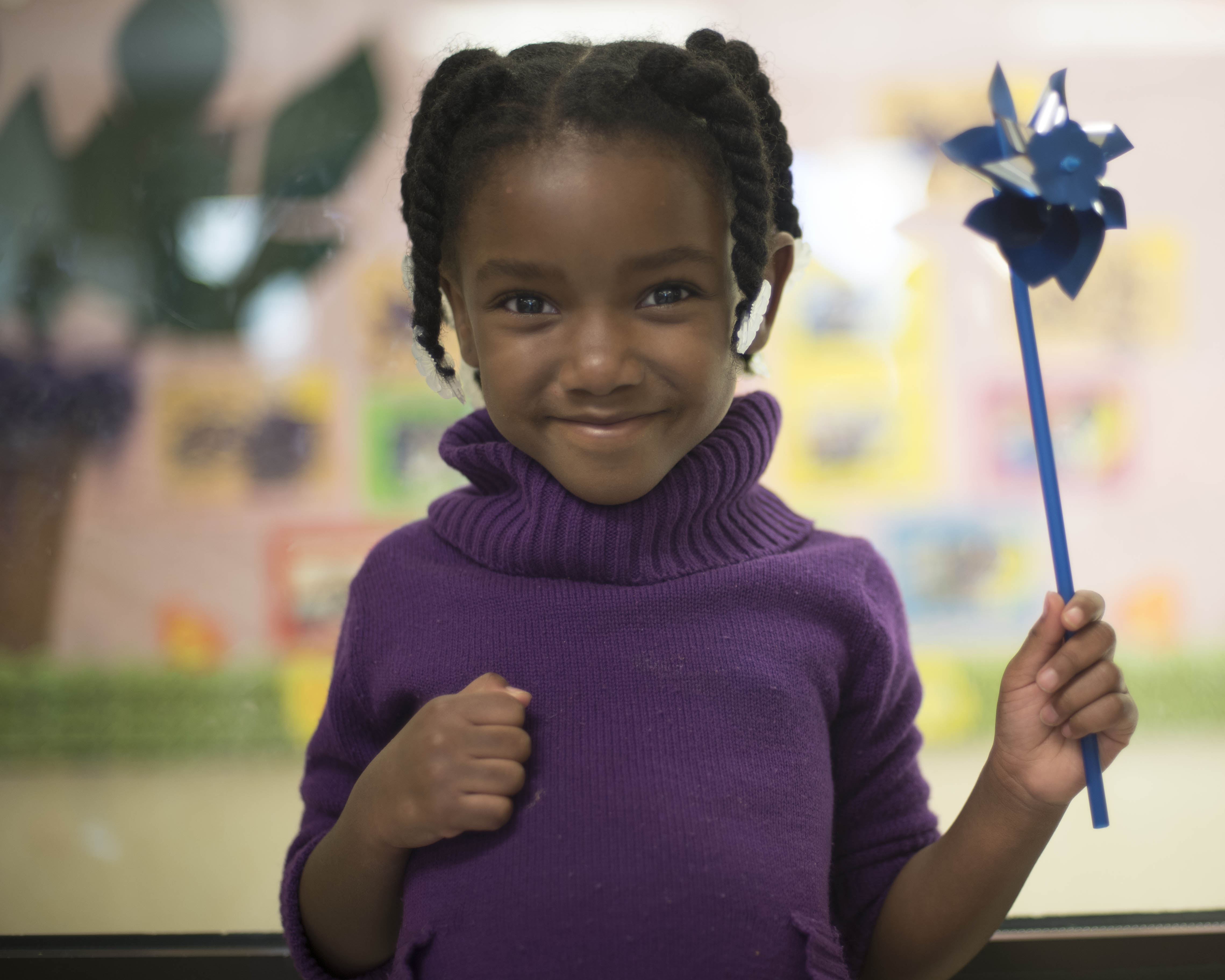 Child holds pinwheel