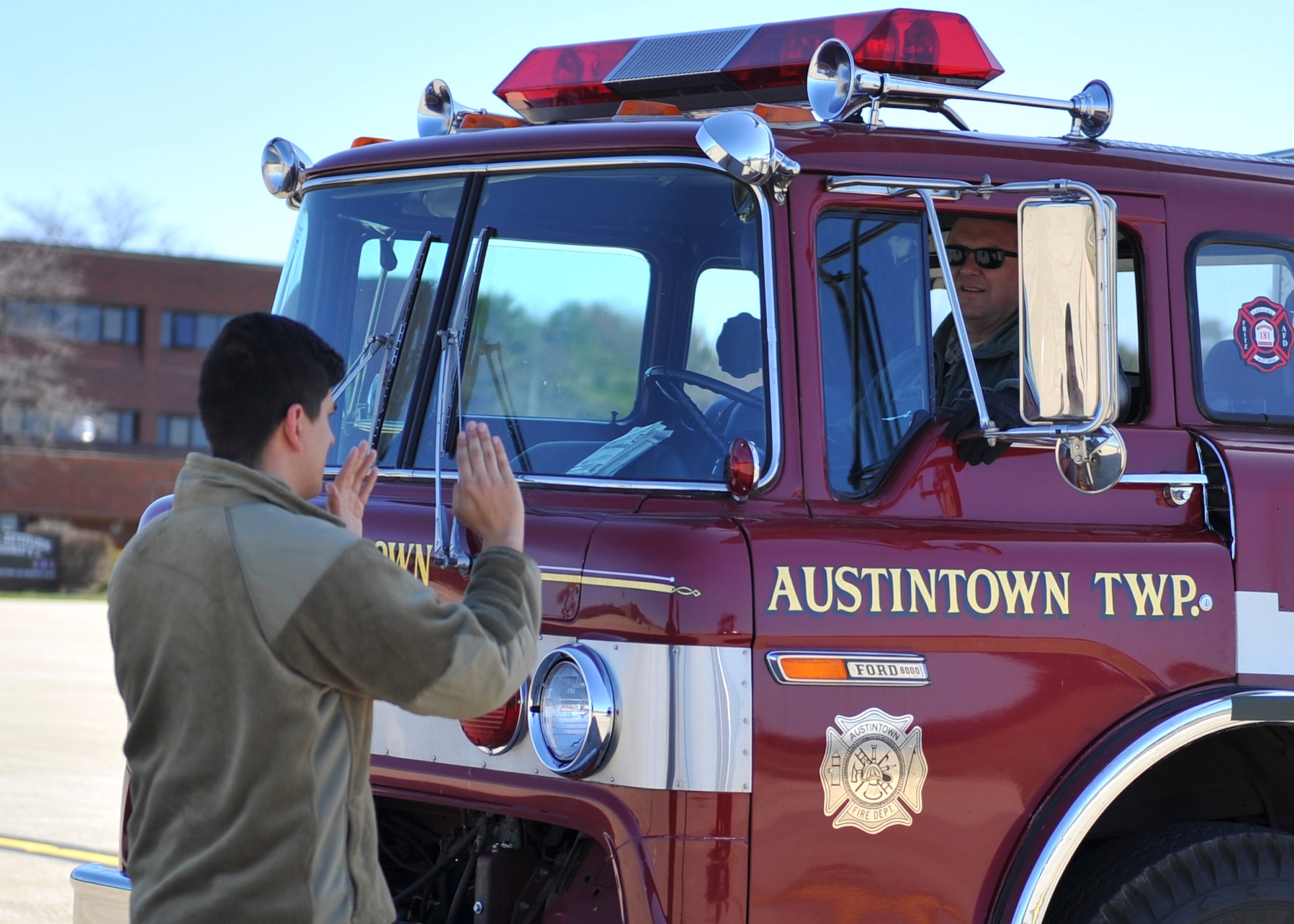 Senior Airman Andrew Flint, a loadmaster with the 21st Airlift Squadron at Travis Air Force Base, California, directs an Austintown Township fire truck driven by Master Sgt. Chris Hornick, Air Terminal Operations Center Section noncommissioned officer in charge with the 76th Aerial Port Squadron, into the back of a C-17 Globemaster III on the flightline here, April 20, 2018.