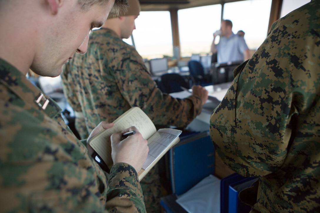 Capt. Richard Klinger, a firepower control team leader with 4th Air Naval Gunfire Liaison Company, Force Headquarters Group, writes coordinates for a possible future target at the Tain Gunfire Range in Tain, Scotland, April 24, 2018.