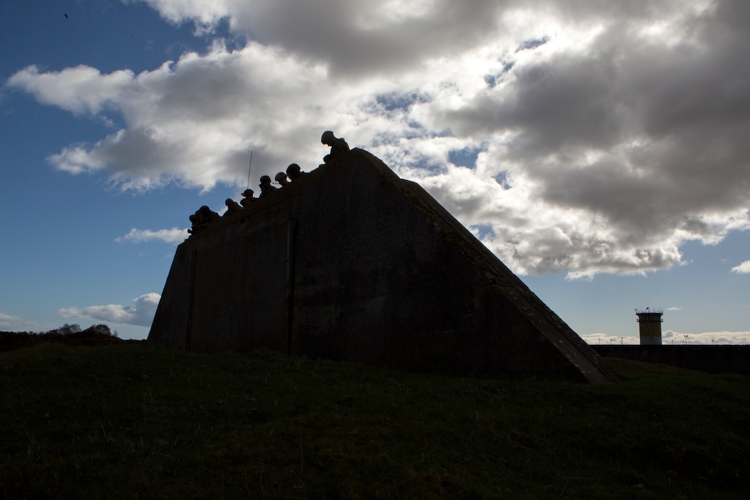 Marines with 4th Air Naval Gunfire Liaison Company, Force Headquarters Group, gather at an observation point to figure out possible target locations during a close air support exercise at the Tain Gunfire Range in Tain, Scotland, April 24, 2018.