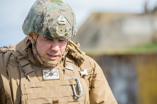 After completing a successful close air support drill, Cpl. David Rodriguez, a forward observer with 4th Air Naval Gunfire Liaison Company, Force Headquarters Group, walks to a debriefing with his firepower control team chiefs at the Tain Gunfire Range in Tain, Scotland, April 24, 2018.