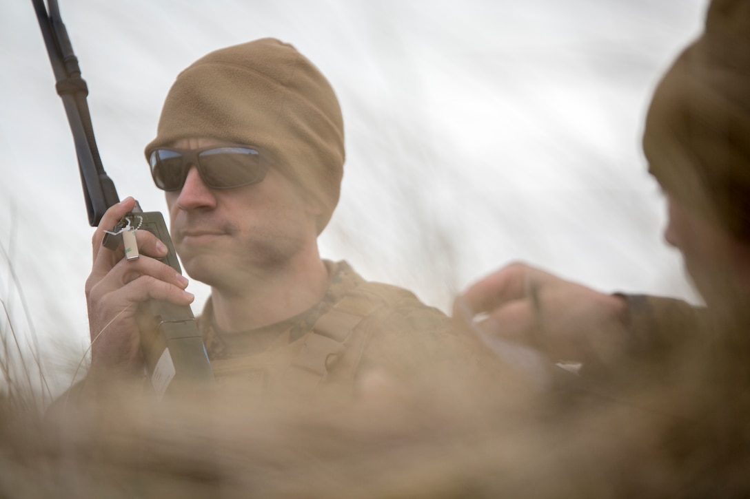 Sgt. Michael Peers, a firepower control team chief with 4th Air Naval Gunfire Liaison Company, Force Headquarters Group, calls in a target location during a close air support exercise at the Tain Gunfire Range in Tain, Scotland, April 24, 2018.