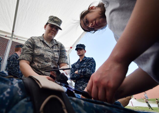Airman 1st Class Amanda Keenan, left, and Airman 1st Class Anabell Salcedo, right, both with the 628th Medical Group, practice applying a tourniquet to a simulated casualty during the 3rd Annual Joint Skills Expo at the Joint Base Charleston Naval Health Clinic April 18, 2018, in Charleston, S.C.