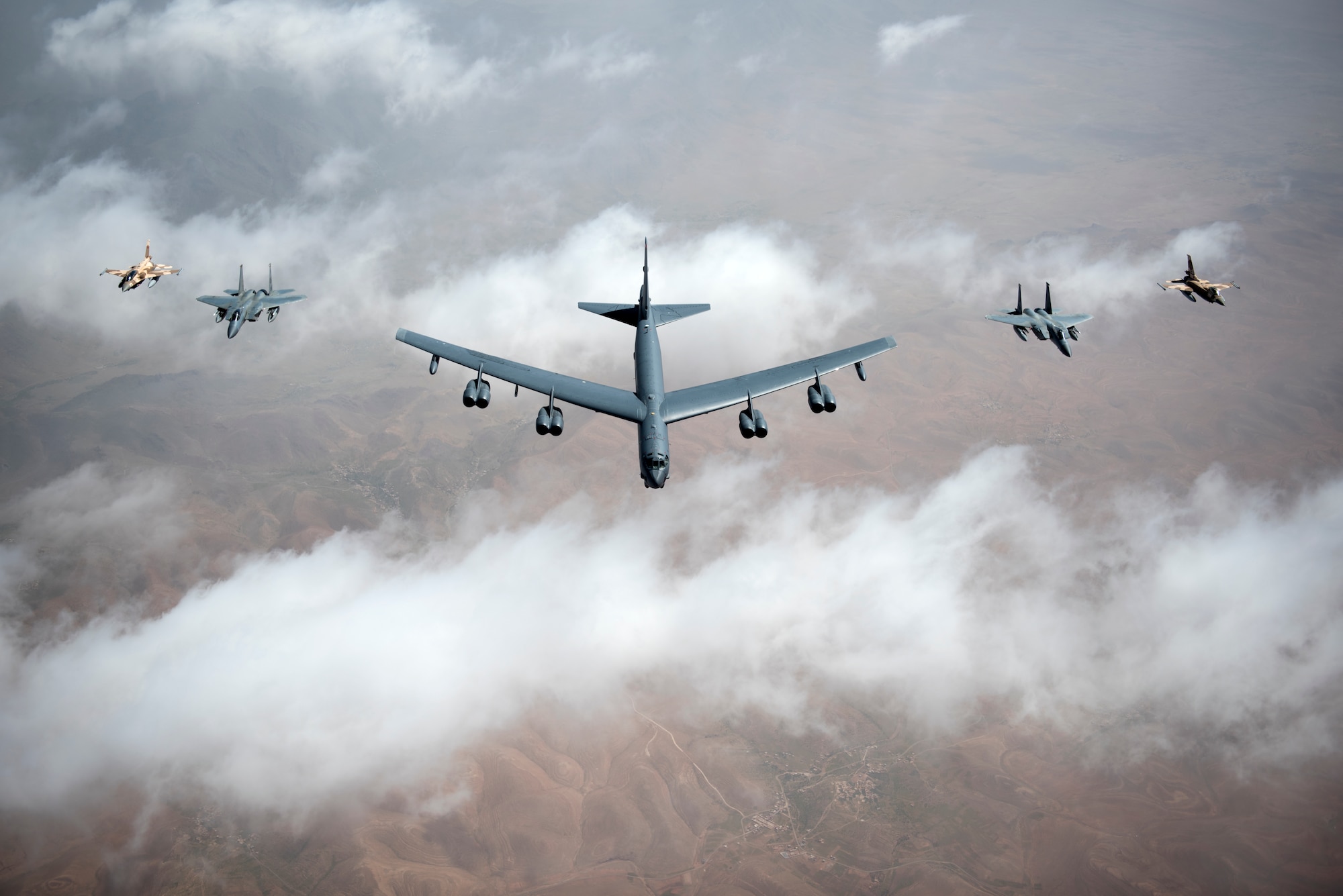 U.S. Air Force F-15Cs, a B-52 Stratofortress bomber and Royal Moroccan air force F-16s fly in a formation during Exercise African Lion April 20, 2018. Various units from the U.S. Armed Forces will conduct multilateral and stability operations training with units from the Royal Moroccan Armed Forces in the Kingdom of Morocco. This combined multilateral exercise is designed to improve interoperability and mutual understanding of each nation’s tactics, techniques and procedures while demonstrating the strong bond between the nation’s militaries. (U.S. Air Force photo/Senior Airman Malcolm Mayfield)