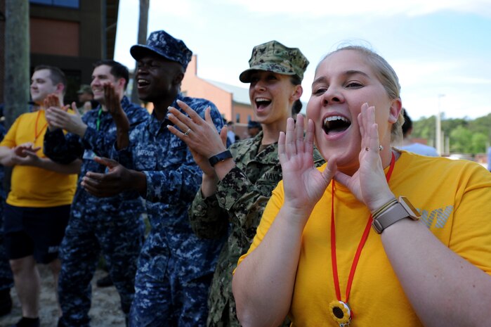 Navy Lt. Samantha Jean Reyes, right, and fellow sailors from Navel Health Clinic Charleston cheer on their follow service members during the 3rd Annual Lowcountry Skills Expo here, April 18, 2018.