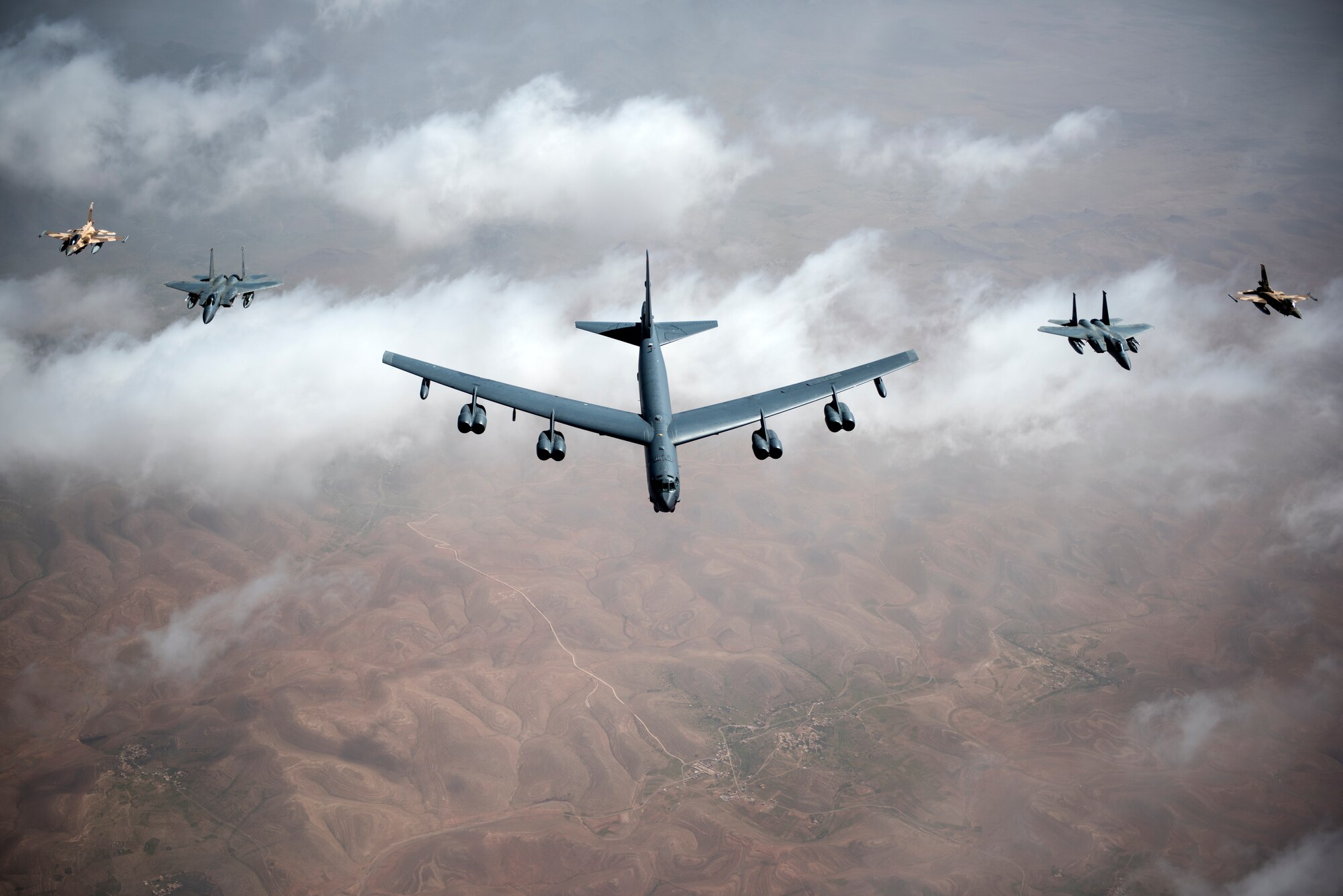 U.S. Air Force F-15Cs, a B-52 Stratofortress bomber and Royal Moroccan air force F-16s fly in a formation during Exercise African Lion April 20, 2018. Various units from the U.S. Armed Forces will conduct multilateral and stability operations training with units from the Royal Moroccan Armed Forces in the Kingdom of Morocco. This combined multilateral exercise is designed to improve interoperability and mutual understanding of each nation’s tactics, techniques and procedures while demonstrating the strong bond between the nation’s militaries. (U.S. Air Force photo/Senior Airman Malcolm Mayfield)