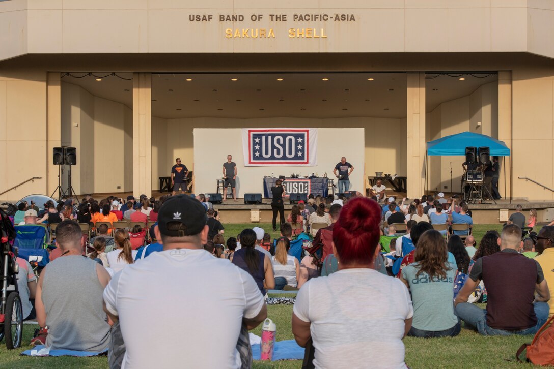 Members of Team Yokota watch as celebrity chef Robert Irvine performs his cooking demonstration during the USO Spring Tour at Yokota Air Base, Japan, April 22, 2018.