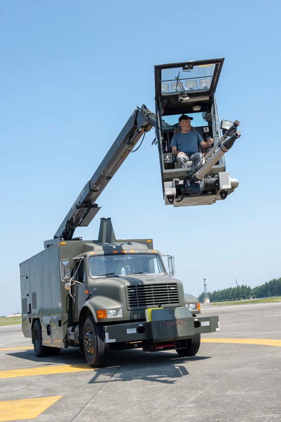 Jon Stewart, writer and comedian, maneuvers himself via a piece of heavy equipment during the vehicle rodeo portion of the USO Spring Tour at Yokota Air Base, Japan, April 22, 2018.