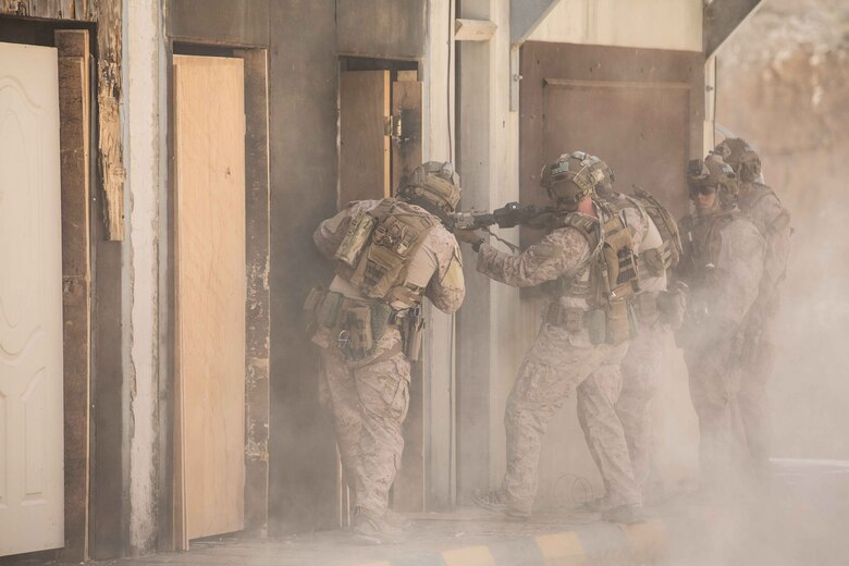 U.S. Marines assigned to the Maritime Raid Force (MRF), 26th Marine Expeditionary Unit (MEU), prepare to clear a room after breaching a door during Eager Lion at the King Abdullah II Special Operations Training Center, Amman, Jordan, April 18, 2018.