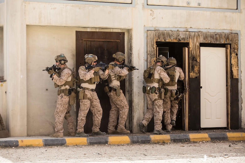 U.S. Marines assigned to the Maritime Raid Force (MRF), 26th Marine Expeditionary Unit (MEU), prepare to clear a room after breaching a door during Eager Lion at the King Abdullah II Special Operations Training Center, Amman, Jordan, April 18, 2018.