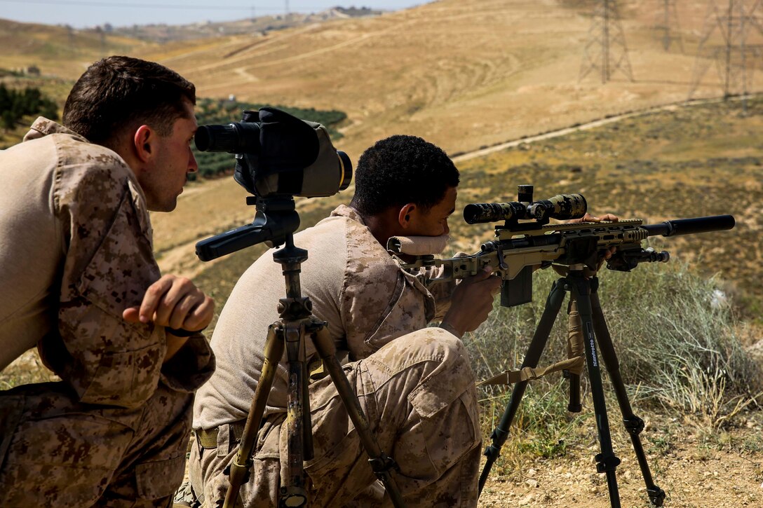 A U.S. Marine assigned to Scout Sniper Platoon, 26th Marine Expeditionary Unit (MEU), fires at a long range target during exercise Eager Lion at the King Abdullah II Special Operations Training Center, Jordan, April 17, 2018. Eager Lion is a capstone training engagement that provides U.S. forces and the Jordan Armed Forces an opportunity to rehearse operating in a coalition environment and to pursue new ways to collectively address threats to regional security and improve overall maritime security. (U.S. Marine Corps photo by Cpl. Jon Sosner/Released)