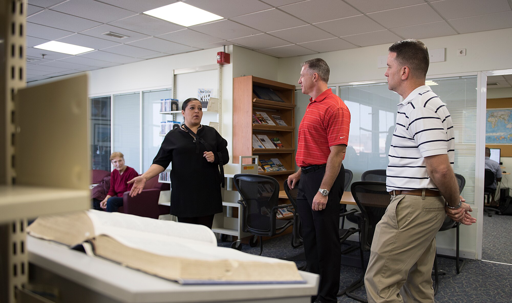 Commander speaks to individual in library