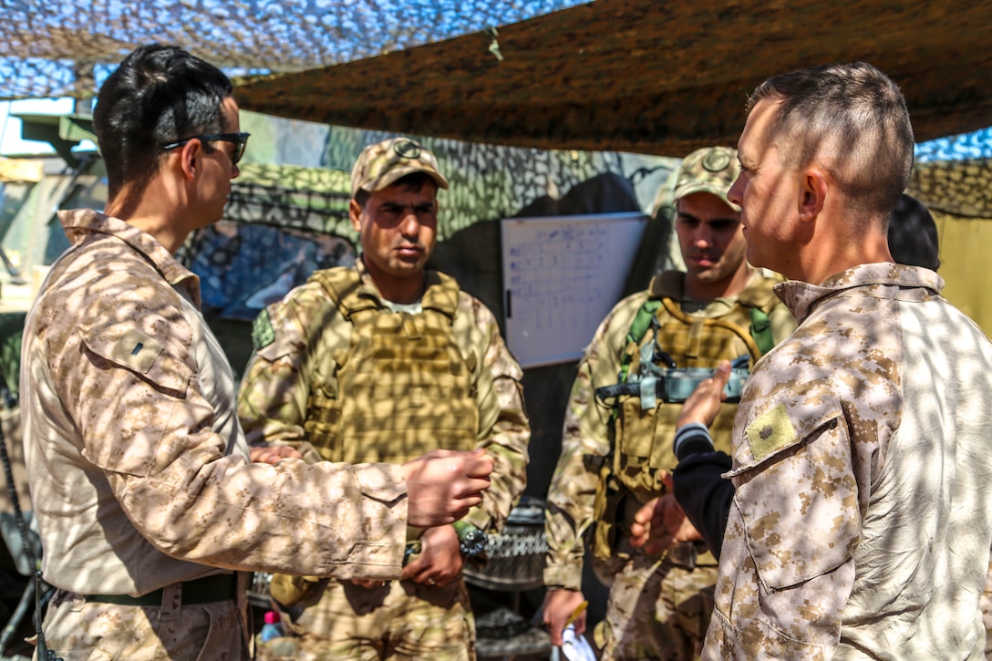 JORDAN (April 23, 2018) U.S. Marine Corps 1st Lt. Melero (left), training officer assigned to Battalion Landing Team, 2nd Battalion, 6th Marine Regiment (BLT 2/6), 26th Marine Expeditionary Unit, discusses training goals and capabilities with Jordanian soldiers with the 91st Battalion, Quick Reaction Force, Jordanian Armed Forces during the bilateral fire support coordination exercise (FSCEX), during exercise Eager Lion in Al Quwayrah, Jordan, April 23, 2018. Eager Lion is a capstone training engagement that provides U.S. forces and the Jordan Armed Forces an opportunity to rehearse operating in a coalition environment and to pursue new ways to collectively address threats to regional security and improve overall maritime security.  (U.S. Marine Corps photo by Gunnery Sgt. Eric L. Alabiso II/Released)