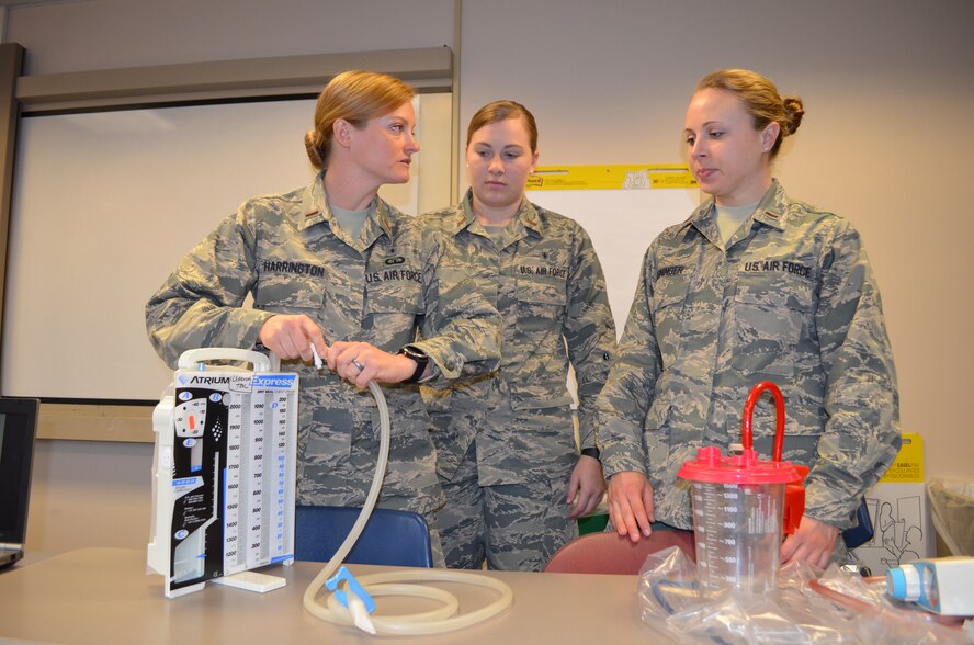 2nd Lt.'s Hunni Harrington, Jenna Schuckman and Rachel Reininger take apart a chest tube during a classroom
course Feb. 16 as part of the Nurse Transition Program at UC Medical Center. (Courtesy photo)