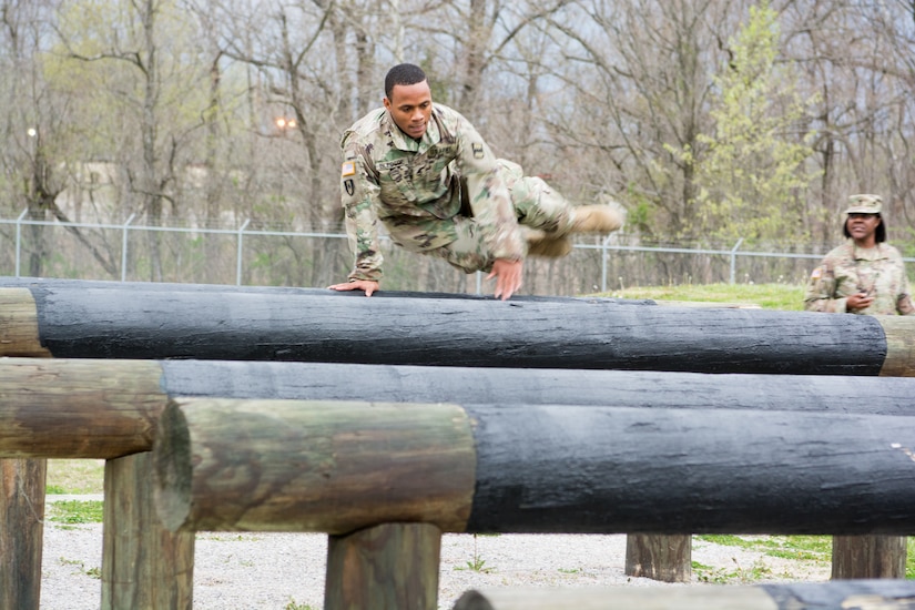 Staff Sgt. Paris Bledsoe, assigned to the 5th Brigade Health Services, 94th Training Division – Force Sustainment, jumps over multiple raised logs in the obstacle course portion of the 80th Training Command's 2018 Best Warrior Competition at Fort Knox, Kentucky, April 14, 2018. (U.S. Army Reserve photo by Maj. Addie Leonhardt, 80th Training Command)