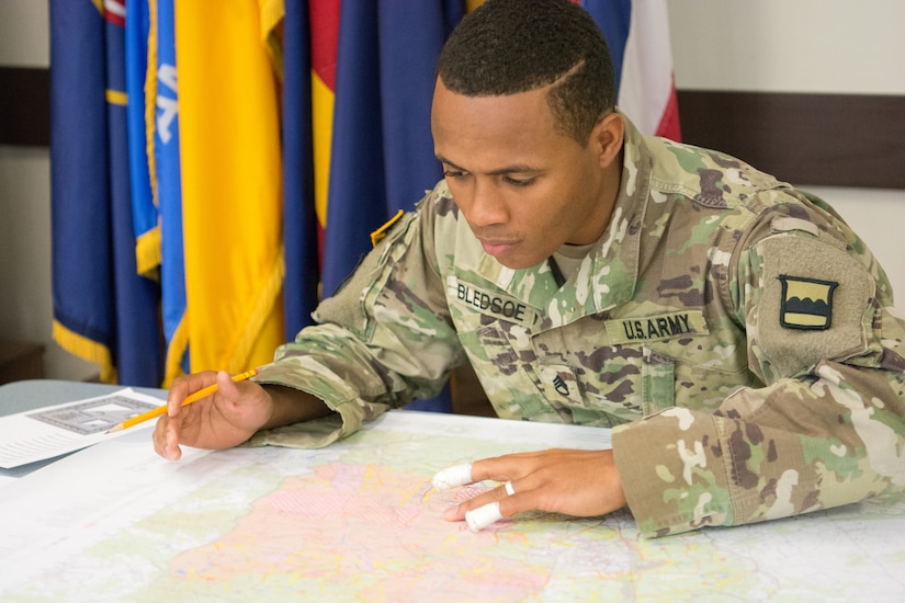 Staff Sgt. Paris Bledsoe, assigned to the 5th Brigade Health Services, 94th Training Division – Force Sustainment, works on the plotting points as part of the Army Warrior Tasks portion of the 80th Training Command's 2018 Best Warrior Competition at Fort Knox, Kentucky, April 14, 2018. (U.S. Army Reserve photo by Maj. Addie Leonhardt, 80th Training Command)
