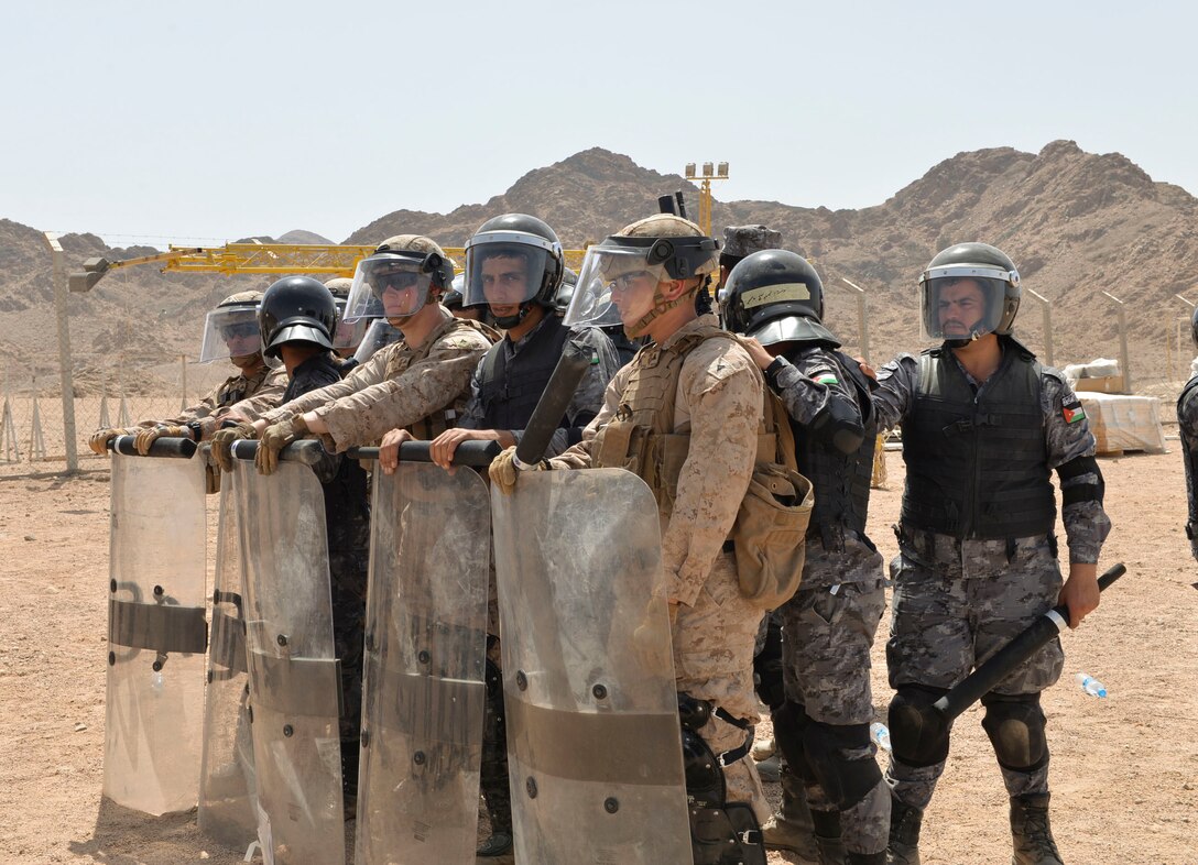 U.S. Marines with Fleet Anti-Terrorism Security Team – Central Command and Jordanian 77th Marines Battalion train together in riot control measures during exercise Eager Lion 2018, April 18, 2018. Eager Lion is a capstone training engagement that provides U.S. forces and the Jordan Armed Forces an opportunity to rehearse operating in a coalition environment and to pursue new ways to collectively address threats to regional security and improve overall maritime security.  (U.S. Navy photo by Mass Communication Specialist 1st Class Sandi Grimnes Moreno/released)