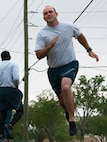 Senior AIrman Craig McMullan, 919th Special Operations Civil Engineer Squadron, appears to get airborne as he accelerates through a turn on the running track at Duke Field, Florida