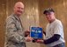 377th Security Forces Squadron Commander Maj. Eric Judd (left) receives a plaque confirming the shared legacy and brotherhood of his unit with the 377th Security Police Squadron from Ton Son Nhut Air Base, South Vietnam from 377th SPS member Tim Clifford.