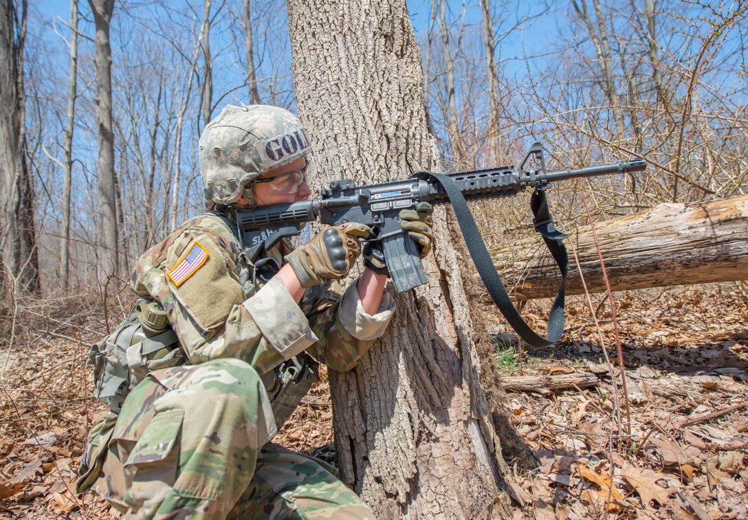 A West Point cadet fires a rifle.