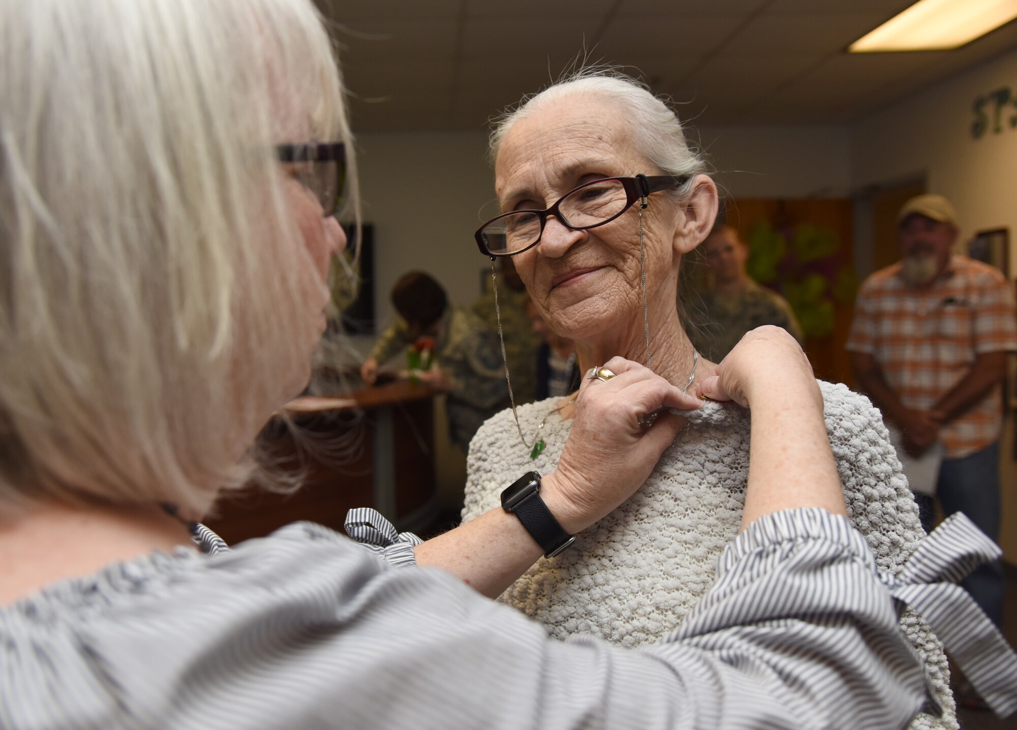 Jackie Pope, 81st Force Support Squadron Airman & Family Readiness Center chief, presents Jackie Hardee, Gold Star Family Member, with a Gold Star Family Member lapel pin at the Sablich Center at Keesler Air Force Base, Mississippi, April 24, 2018. As a surviving parent of a killed in action service member, Hardee is allowed to obtain an ID card for recognition and installation access so that she can attend events and access Airmen and Family Readiness Center referral services. (U.S. Air Force photo by Kemberly Groue)