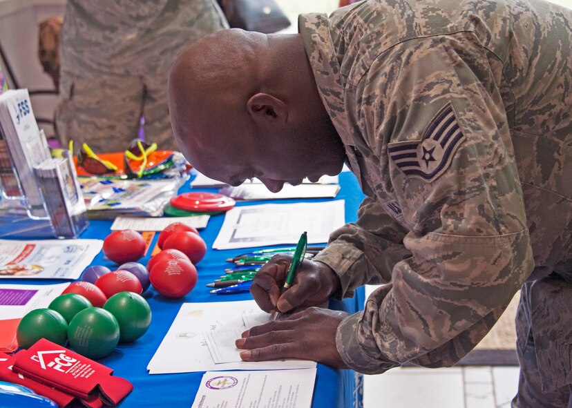A 919th Special Operations Wing Airman fills out a post card for a  young family member inside the dining facility entrance at Duke Field, Florida, April 7, 2018
