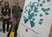 Elizabeth Henze, 934th Airlift Wing Sexual Assault Response Coordinator, and Staff Sgt. Andrea Huelsnitz, 934th Aircraft Maintenance Squadron, display the Sexual Assault Awareness wall April 7 where Airmen "stick it to sexual assault" with personal pledges placed on the wall.  By the end of the day, the wall was covered with pledges from 934th Airmen.  (Air Force Photo/Paul Zadach)