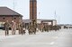 A line of Airmen walk along Flightling Road to where their families await, just outside the 5-Bay.