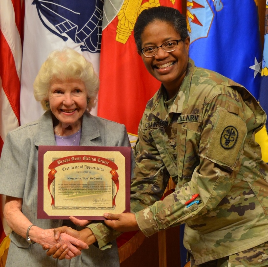 Army Col. Traci Crawford, Brooke Army Medical Center deputy commanding officer, poses for a photo with Sue McCarthy, BAMC Auxiliary Volunteer of the Year, during the BAMC Volunteer Recognition Ceremony April 16.