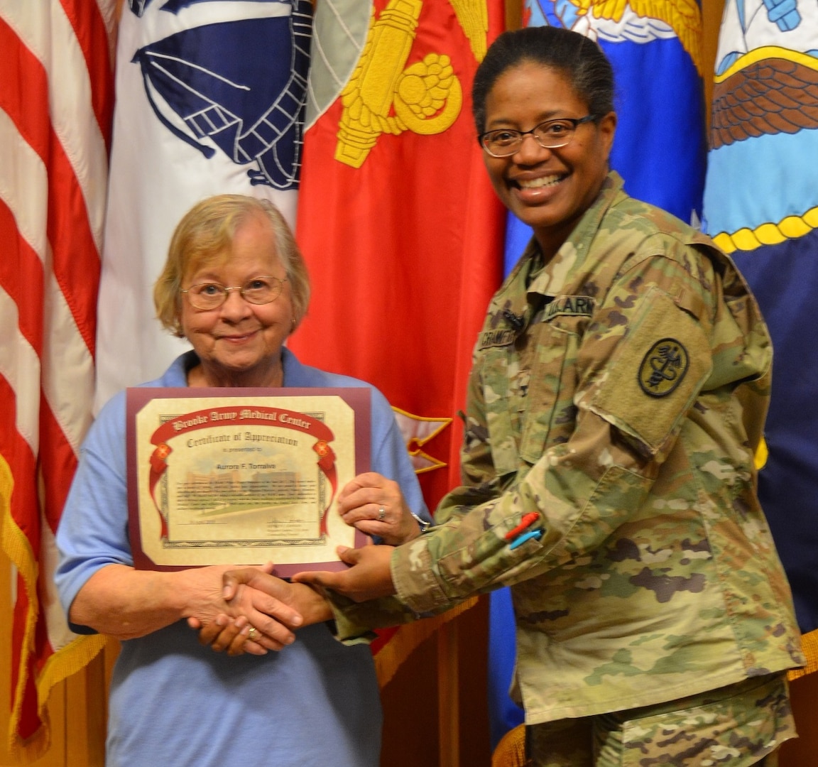 Army Col. Traci Crawford, Brooke Army Medical Center deputy commanding officer, poses for a photo with Aurora Torralva, BAMC Fisher House Volunteer of the Year, during the BAMC Volunteer Recognition Ceremony April 16.