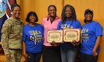 Army Col. Traci Crawford, Brooke Army Medical Center deputy commanding officer, poses for a photo with members of the Ministry Ward Social Team, BAMC Group of the Year, during the BAMC Volunteer Recognition Ceremony April 16.