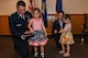 A family affair. Lt. Cols. Shane and Jennifer Garrison receive help from their children during a shared promotion ceremony at Barksdale Air Force Base, La., April 20, 2018.