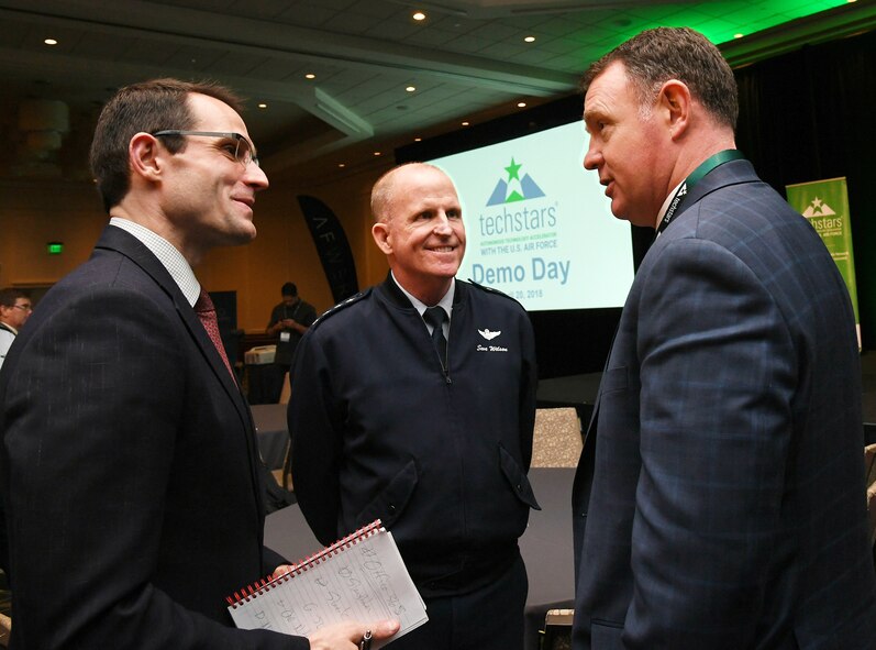 Air Force Vice Chief of Staff Gen. Stephen W. Wilson, left, and Dr. William Roper, assistant secretary of the Air Force for Acquisition, Technology and Logistics, center, discuss the April 20 TechStars Autonomous Technology Accelerator for the Air Force Demo Day at the Westin Hotel in Boston with John Beatty, right, executive director of the Massachusetts Military Force.