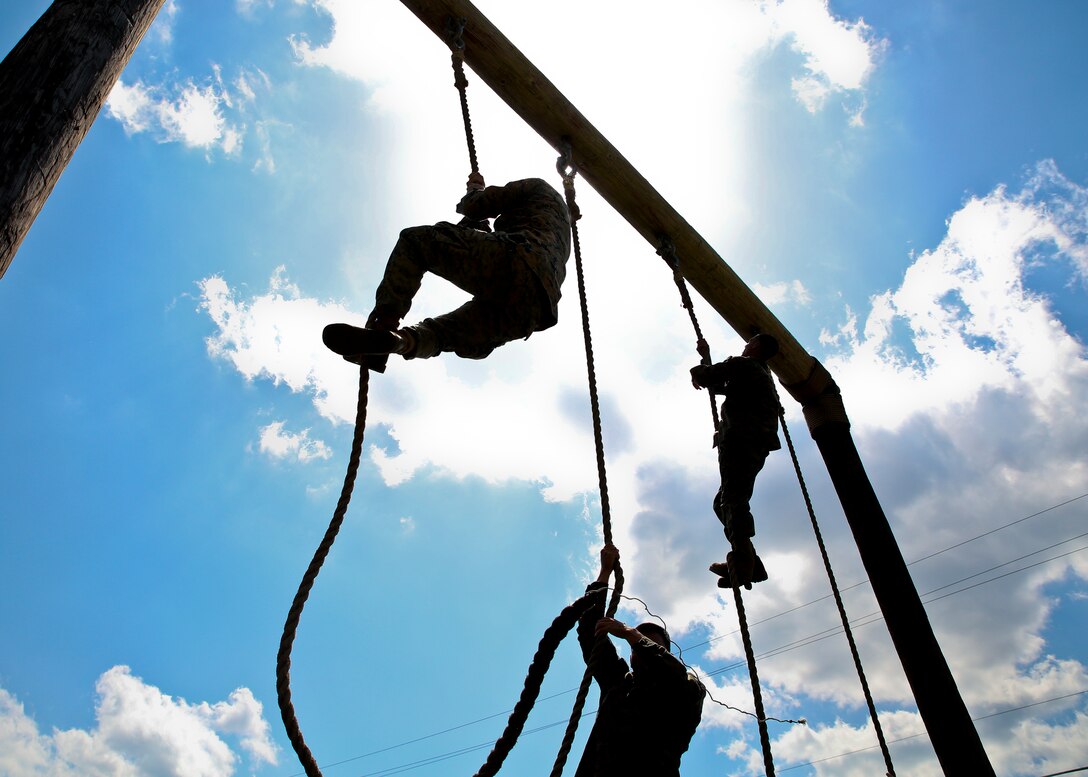 Marines, climb a rope during the Headquarters and Headquarters Squadron physical training aboard Marine Corps Air Station Beaufort April 19. The Swamp Foxes held the PT to build unit cohesion and camaraderie as well as to physically train as a squadron. The PT consisted of a circuit course utilizing the obstacle course. After the circuit course, four Marines volunteered to compete in an obstacle course race.