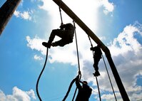 Marines, climb a rope during the Headquarters and Headquarters Squadron physical training aboard Marine Corps Air Station Beaufort April 19.