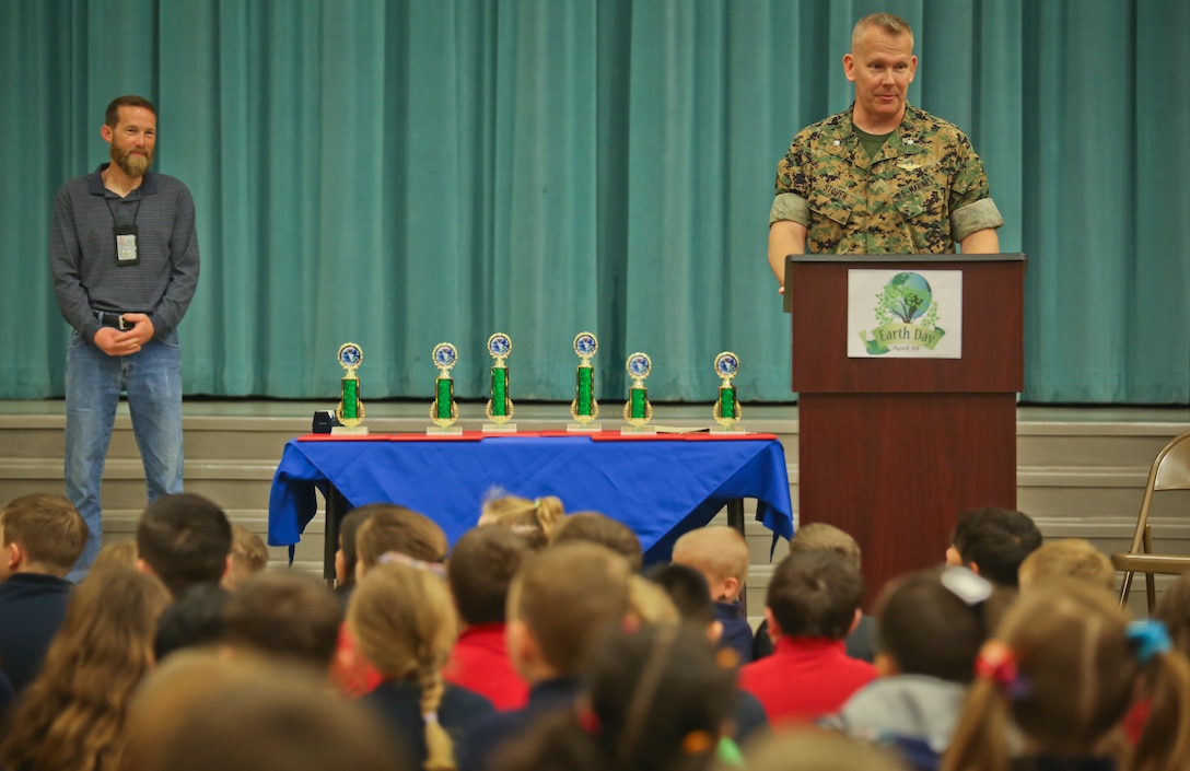 Lt. Col. Matthew Stover adresses students during the Earth Day poster award ceremony aboard Laurel Bay, April 24. Children from Charles F. Bolden Elementary School and Elliott Elementary School competed in the poster contest as a way to educate and involve children on environmental management. This year's theme for the contest was Give a hoot, Don't Pollute. April 22 has been designated as Earth Day since 1970 and across the Marine Corps, installations are participating in Earth Day activities to help remind all Marines, Sailors, civilians, and their families that their everyday actions help protect our resources and contribute to the long-term success of the Marine Corps. Stover is the executive officer of Marine Corps Air Station Beaufort.