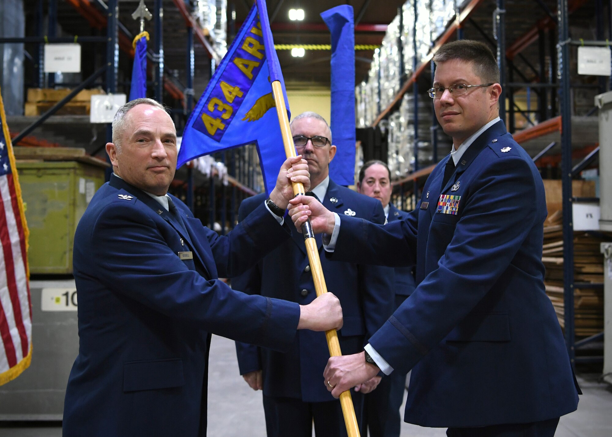 Lt. Col. Christopher Beckley, 49th Aerial Port Squadron, right, accepts the guidon from Col. Scott Russell, 434th Mission Support Group commander, left, as Senior Master Sgt. Kevin Connelly, 49th APS superintendent, center, looks on, during the 49th Aerial Port Squadron re-designation ceremony at Grissom Air Reserve Base, Ind., April 7, 2018. The 49th APS originally constituted on January 29, 1973, as part of the Eastern Air Force Reserve Region assigned to the 514th Military Airlift Wing at McGuire Air Force Base, New Jersey, before being deactivated in 1992 and reassigned to Grissom as the 49th Aerial Port Flight. (U.S. Air Force photo/Staff Sgt. Katrina Heikkinen)