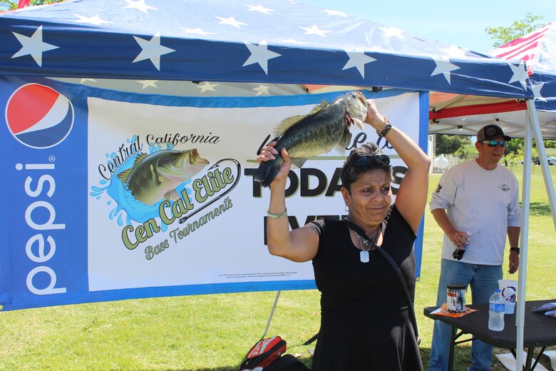 Veteran Roberta May holds her catch above her head during the weigh-in for the biggest fish during the Warrior’s Day on the Lake event April 21.