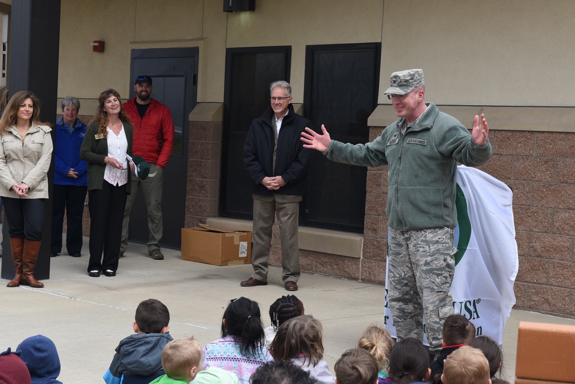 04262018-F-BM731-001
Col. Troy L. Endicott, 460th Space Wing commander, speaks to a group of children from Buckley Air Force Base Child Development Center about the importance of trees during an Arbor Day tree planting ceremony April 26, 2018 on Buckley Air Force Base, Colorado. (U.S. Air Force Photo by Senior Airman Jessica B. Kind)