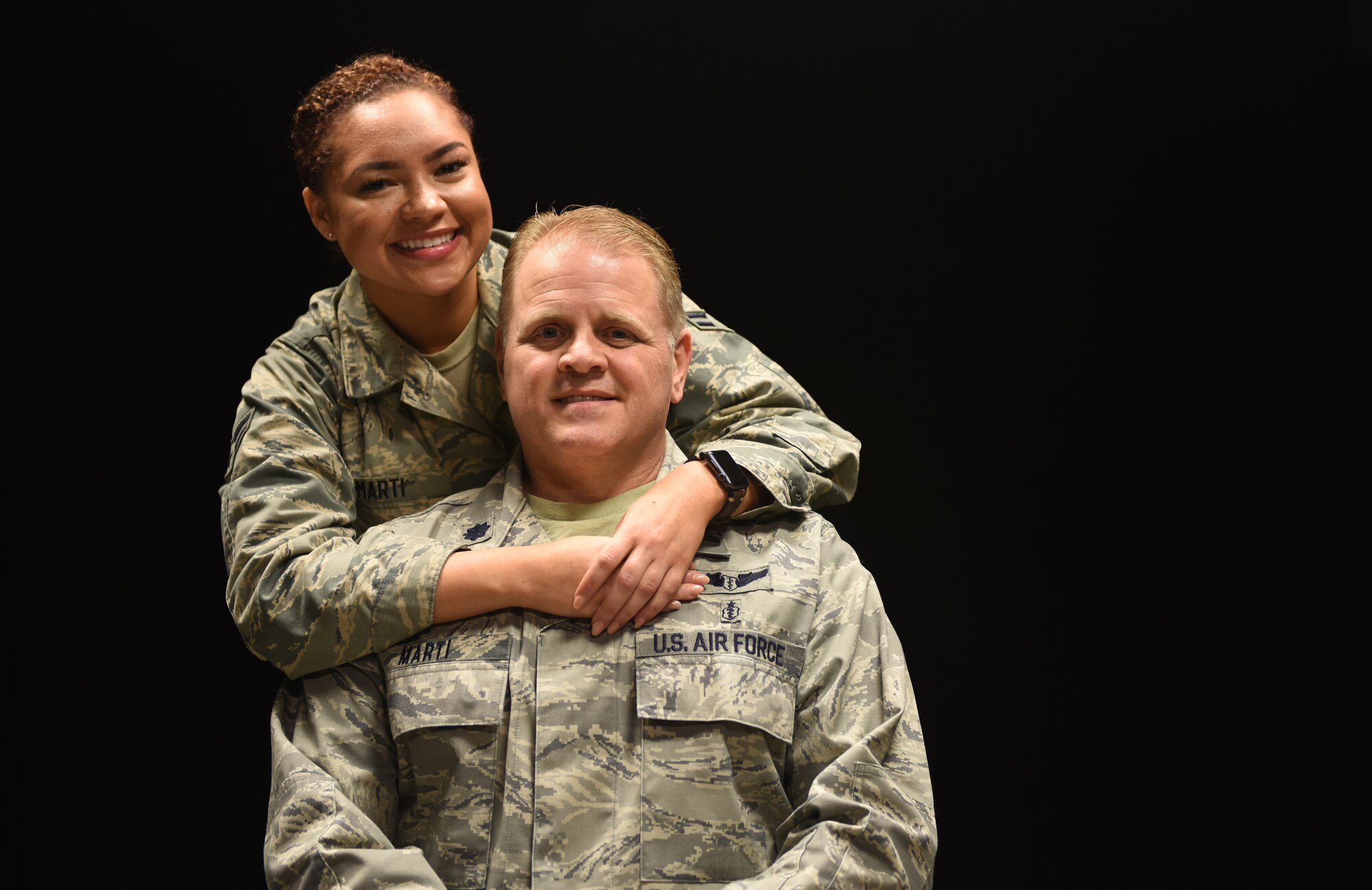 U.S. Air Force Airman 1st Class Alaina Marti, 81st Logistics Readiness Squadron ground transportation dispatcher, and her father, Lt. Col. Jon Marti, 81st Diagnostic and Therapeutics Squadron diagnostic radiologist, pose for a photo at Keesler Air Force Base, Mississippi, April 17, 2018. Alaina decided to join the Air Force after growing up as a military child and seeing her dad serve his country. The Defense Department celebrates Month of the Military Child in April to honor children who grow up with parents in the U.S. military. (U.S. Air Force photo by Senior Airman Holly Mansfield)