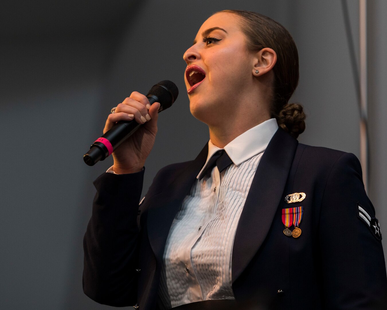Vocalist Airmen 1st Class Michelle Rajotte, from Band of the West performs as part of Fiesta in Blue in San Antonio, Texas April 24, 2018. The act was dedicated to the 300th Anniversary of San Antonio and honors the city's military heritage. Since 1891, Fiesta has grown into an annual celebration that includes civic and military observances, exhibits, sports, music and food representing the spirit, diversity and vitality of San Antonio. (U.S. Air Force photo by Ismael Ortega / Released)