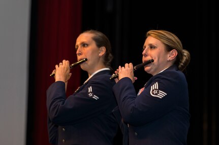 Flutists Airmen 1st Class Elizabeth Robinson (left) and Staff Sgt. Carolyn Sierichs (right), from Band of the West perform as part of Fiesta in Blue in San Antonio, Texas April 24, 2018. The act was dedicated to the 300th Anniversary of San Antonio and honors the city's military heritage. Since 1891, Fiesta has grown into an annual celebration that includes civic and military observances, exhibits, sports, music and food representing the spirit, diversity and vitality of San Antonio. (U.S. Air Force photo by Ismael Ortega / Released)