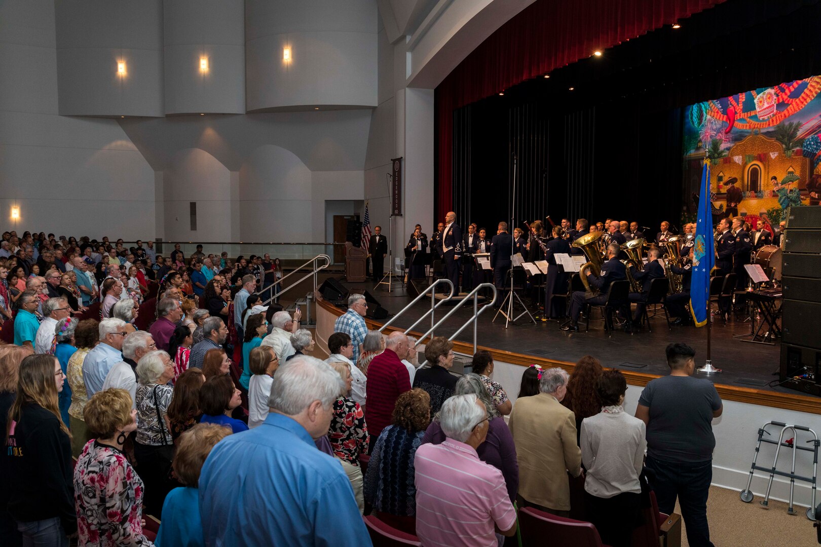 Civilians and military members render honors as the national anthem is played prior the Band of the West performance in San Antonio, Texas April 24, 2018. The act was dedicated to the 300th Anniversary of San Antonio and honors the city's military heritage. Since 1891, Fiesta has grown into an annual celebration that includes civic and military observances, exhibits, sports, music and food representing the spirit, diversity and vitality of San Antonio. (U.S. Air Force photo by Ismael Ortega / Released)