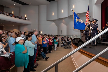 Civilians and military members render honors as the national anthem is played prior the Band of the West performance in San Antonio, Texas April 24, 2018. The act was dedicated to the 300th Anniversary of San Antonio and honors the city's military heritage. Since 1891, Fiesta has grown into an annual celebration that includes civic and military observances, exhibits, sports, music and food representing the spirit, diversity and vitality of San Antonio. (U.S. Air Force photo by Ismael Ortega / Released)