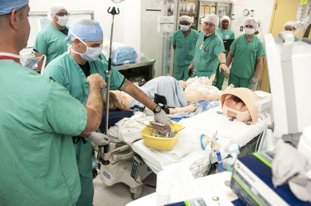 Medical personnel from William Beaumont Army Medical Center on Fort Bliss, Texas, prepare for treatment of a simulated postpartum hemorrhage using the center’s new simulation system.