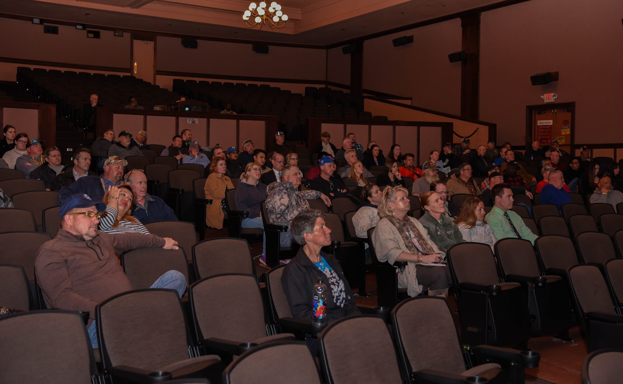 A group of civilians sit and listen during a civilian all-call on F.E. Warren Air Force Base, Wyoming, April 24, 2018. During the all-call, the speakers consistently reminded the attendees that civilians are an integral part of the Air Force family. (U.S. Air Force photo by Airman 1st Class Braydon Williams)