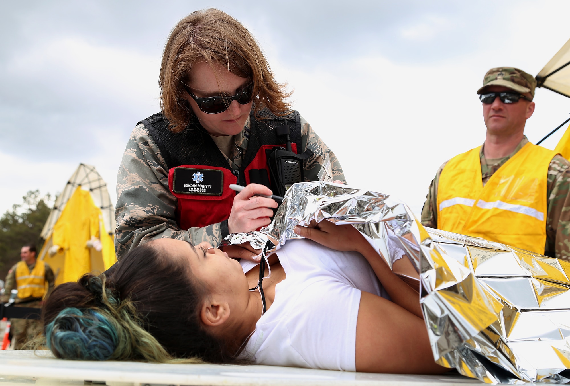 Capt. Megan C. Martin, a nurse assigned to the 157th Medical Group, N.H. Air National Guard, documents the condition of a simulated casualty onto a triage card during a deployment readiness exercise on April 11, 2018 at Joint Base Cape Cod, Mass. Martin is a member of the New England CBRNE Enhanced Response Force Package team. (N.H. Air National Guard photo by Staff Sgt. Kayla White)