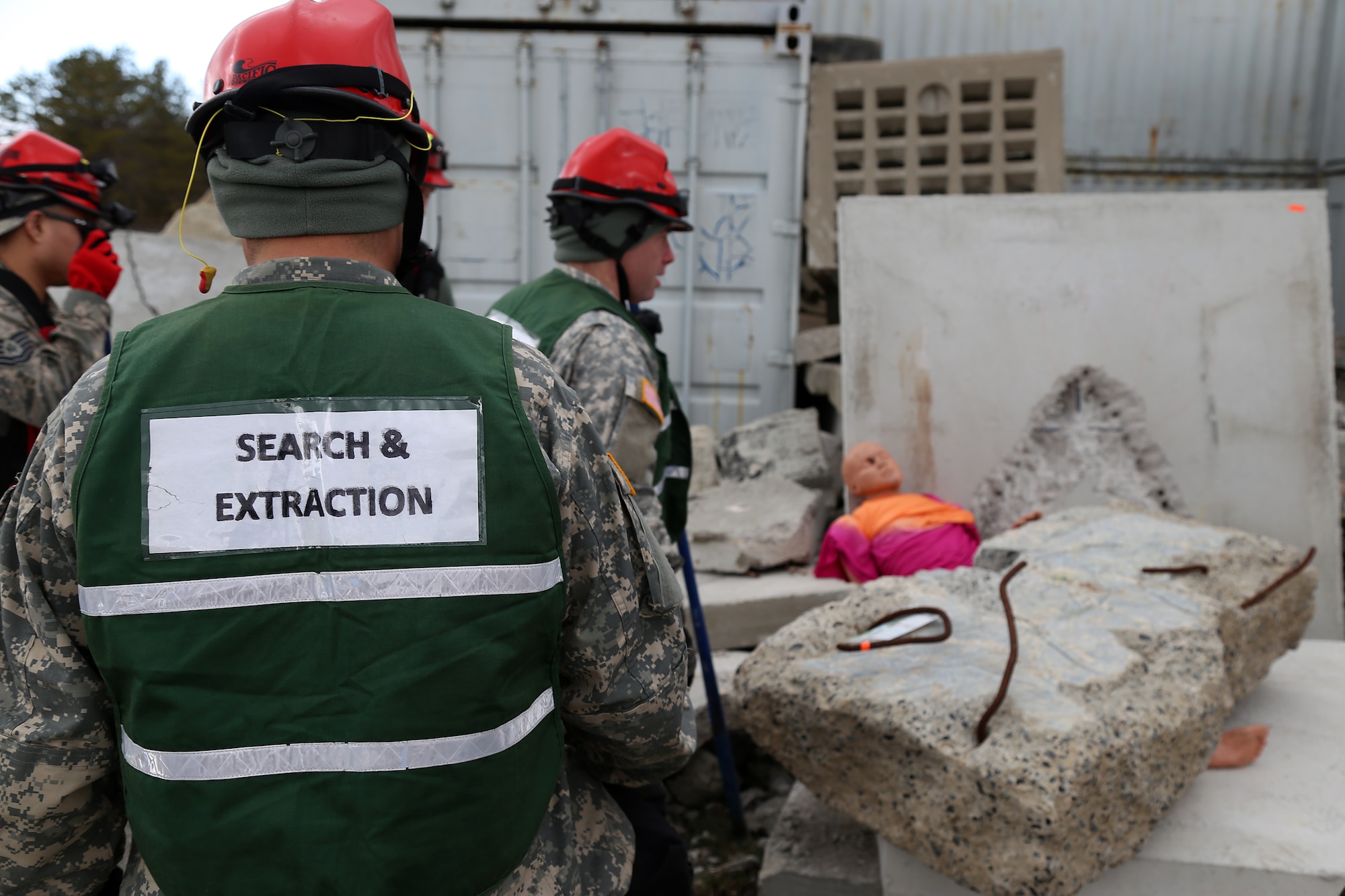 Members of the New England CBRNE Enhanced Response Force Package (CERFP) search and extraction team prepare to rescue a simulated casualty on April 11, 2018 at Joint Base Cape Cod, Mass. National Guardsmen participated in the weeklong deployment readiness exercise. (N.H. Air National Guard photo by Staff Sgt. Kayla White)