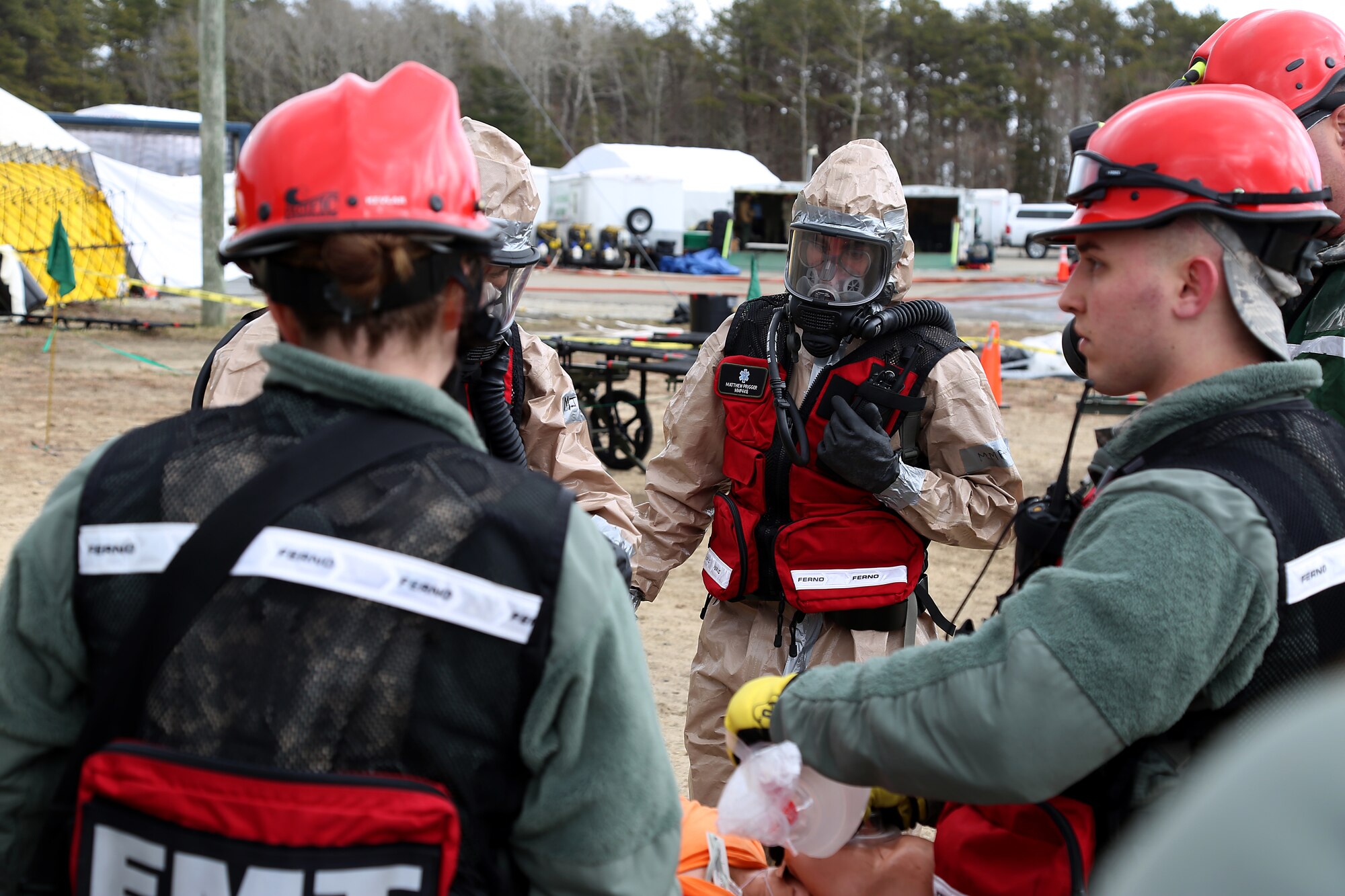 Tech. Sgt. Matthew T. Prugger, a flight operations medical technician assigned to the 157th Medical Group, N.H. Air National Guard, directs members of the medical search and extraction team through the decontamination tents during a simulated exercise on April 11, 2018 at Joint Base Cape Cod, Mass. The medics participated in a joint deployment readiness exercise as part of the New England CBRNE Enhanced Response Force Package team. (N.H. Air National Guard photo by Staff Sgt. Kayla White)